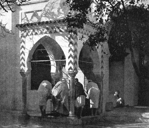 ABLUTION AT THE FOUNTAIN BEFORE PRAYER IN THE MOSQUE.